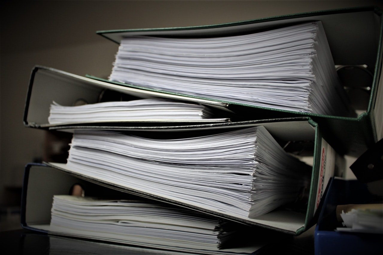 Image of stacked lever-arch folders.